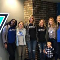 smaller group gathers for picture indoors